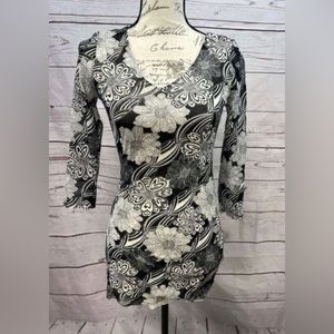 CAbi medium black and white floral patterned blouse. 3/4 sleeves.